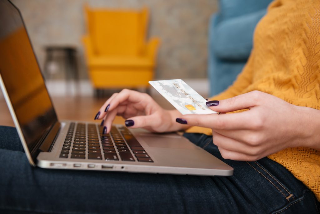 Close up of a woman buying online with bank card