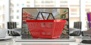 Supermarket online shopping. Shopping basket on a laptop.3d illustration